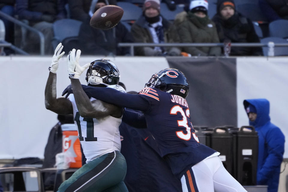 Philadelphia Eagles' A.J. Brown, left, catches a pass against Chicago Bears' Jaylon Johnson during the second half of an NFL football game, Sunday, Dec. 18, 2022, in Chicago. (AP Photo/Charles Rex Arbogast)