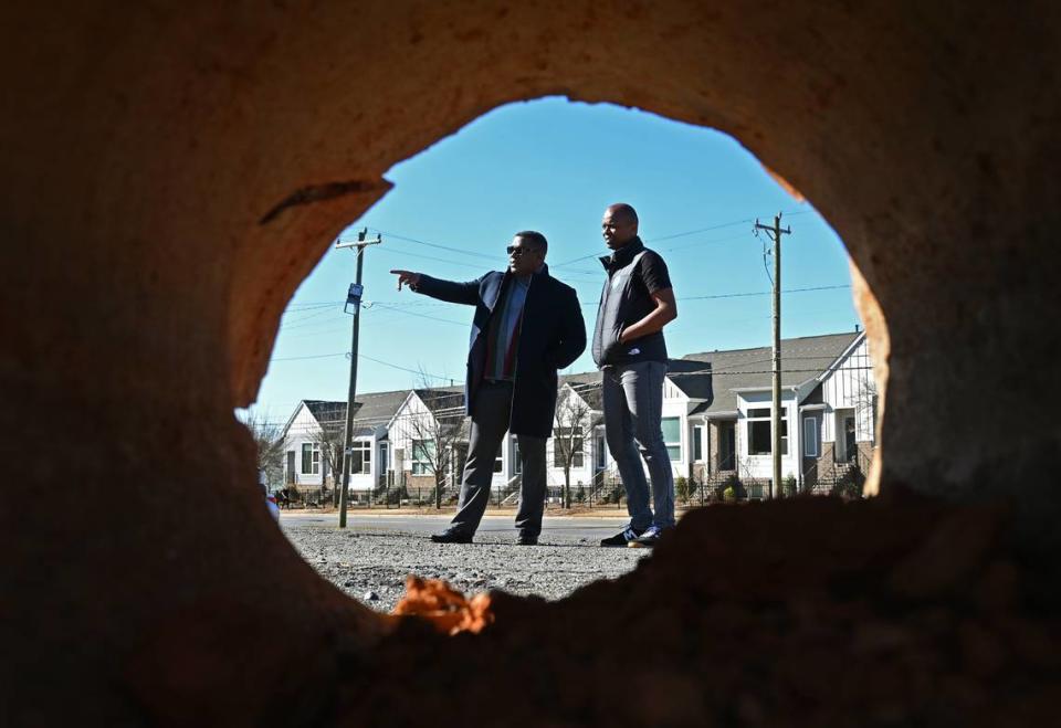 William Haygood, left, and Rodney Faulkner stand on a 6-acre vacant site, not far from Camp North End, that they plan to develop into apartments, town homes and an 8,000 square foot grocery store.