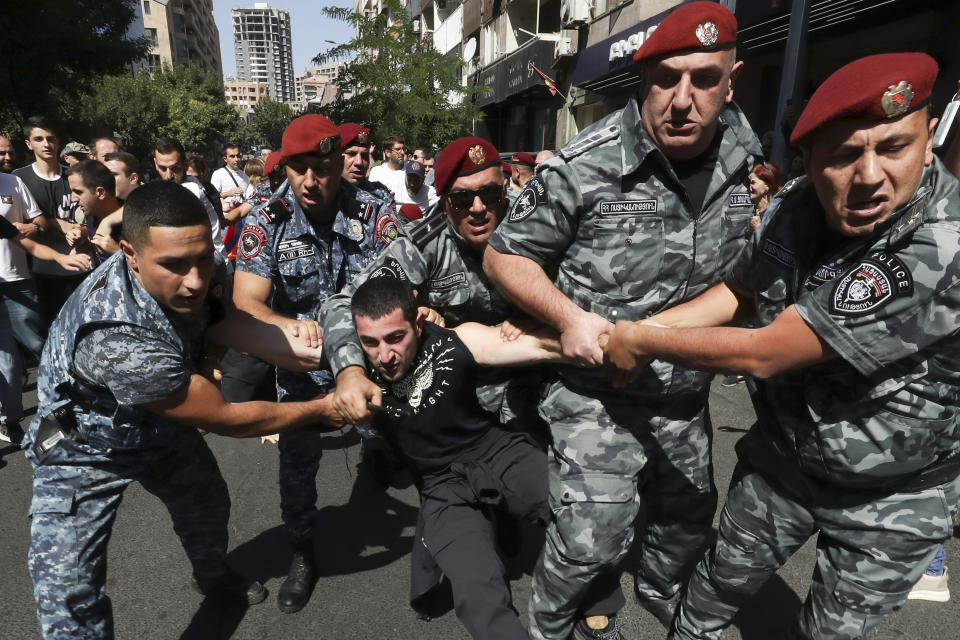 Policer officers detain a demonstrator during a protest against Prime Minister Nikol Pashinyan in Yerevan, Armenia, Friday, Sept. 22, 2023. (Vahram Baghdasaryan/Photolure via AP)
