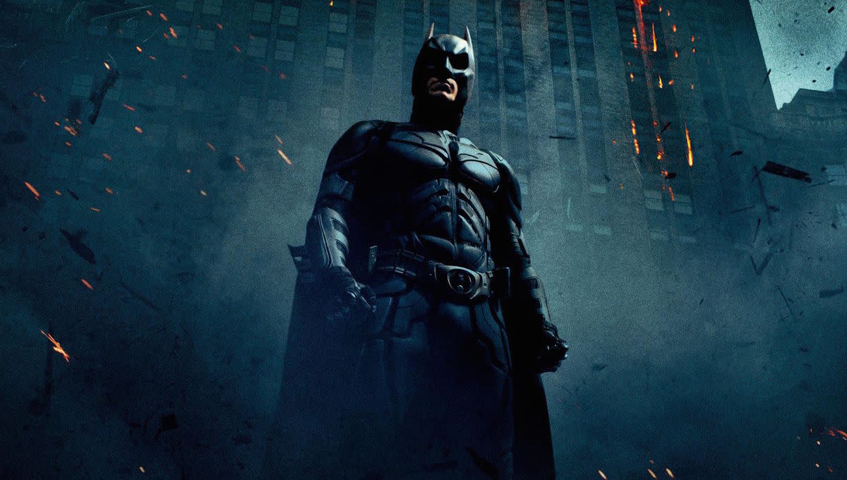  A promotional image for 2008's The Dark Knight, one of the entries in our Batman movies in order guide, which shows Batman in front of a burning building. 