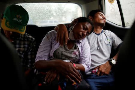 Eufemia Garcia, 48, who lost 50 members of her family during the eruption of the Fuego volcano, sleeps next to her partner, Fito Perez, after searching for her family in in San Miguel Los Lotes Escuintla, Guatemala, June 14, 2018. REUTERS/Carlos Jasso