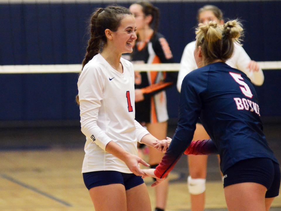 Boyne City senior Ava Tarsi (left) celebrates with fellow senior Aubrey Burns during Tuesday's match against Harbor Springs.