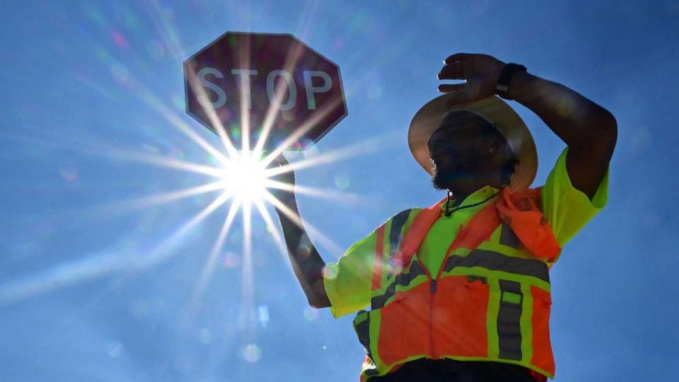 PHOTO: Traffic warden Rai Rogers mans his street corner under the hot sun in Las Vegas, Nevada on July 12, 2023, where temperatures reached 106 degrees amid an ongoing heatwave. (Frederic J. Brown/AFP via Getty Images)