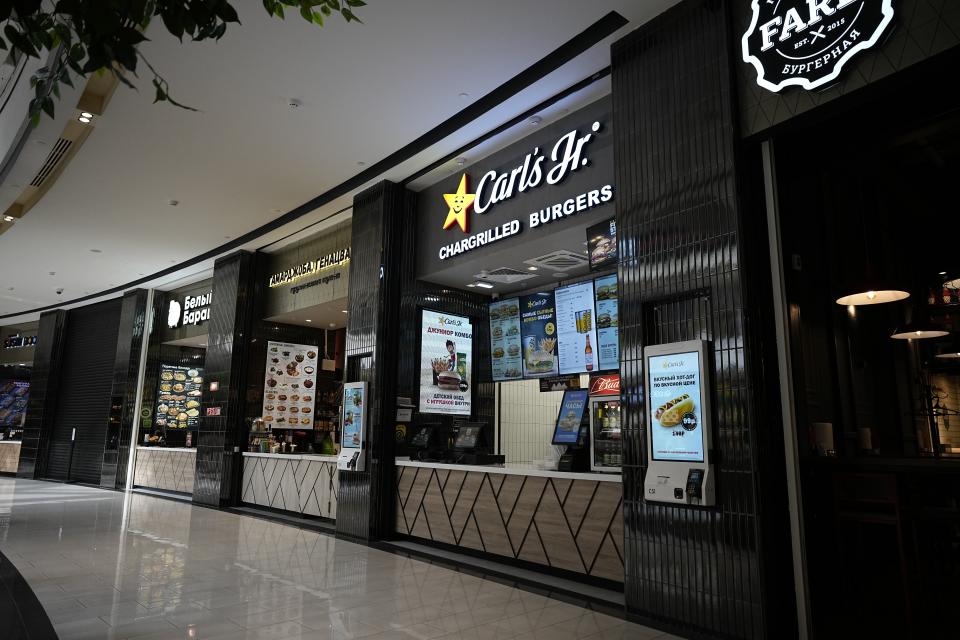 A Carl's Jr. kiosk is seen at Paveletskaya Plaza shopping mall in Moscow, Russia, Wednesday, May 3, 2023. When Russia invaded Ukraine, companies were quick to respond, some announcing they would get out of Russia immediately, others vowed to curtail sales and new investment. More than a year later, it’s clear: Leaving Russia isn't as easy as the first announcements might have made it seem. (AP Photo/Alexander Zemlianichenko)