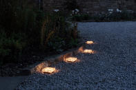 <p> Perfect for outlining the curviest of garden path ideas, these neat, little lights are solar powered. Thanks to their inbuilt sensor they will turn on at dusk and give out a warm and welcoming glow. </p> <p> Made from ice-effect glass they are robust enough to be left out all year-round. Simply place one every 20in or so along the edge of the path – they can be easily moved if needed. </p>