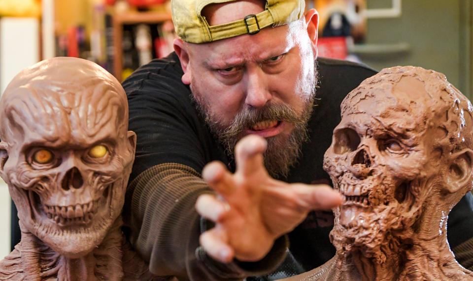 Jonathan Thornton, owner of Southern Fried Monsters, poses with some works in progress at his monster studio in Montgomery on Oct 5.
