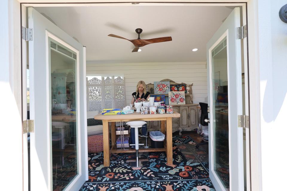 Artist Hannie Clark works in her backyard shed at her home in Pleasant Grove on Wednesday, June 21, 2023. A Utah company builds them using residential construction methods and materials and are under 200 square feet qualifying them as “sheds,” helping avoid licenses. | Jeffrey D. Allred, Deseret News