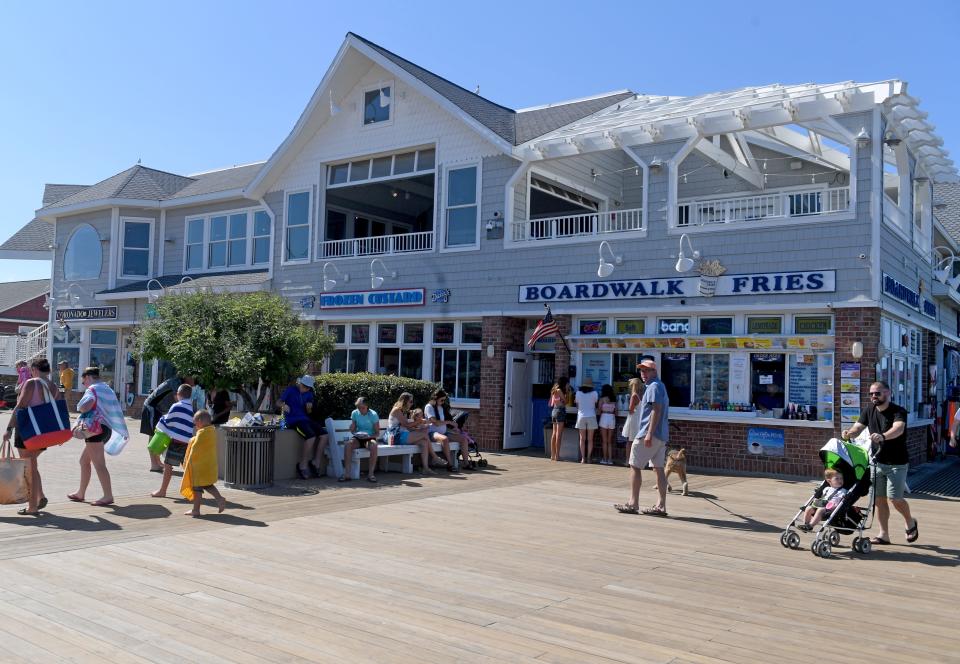 People visit shops on the boardwalk Thursday, June 17, 2021, in Bethany Beach, Delaware.