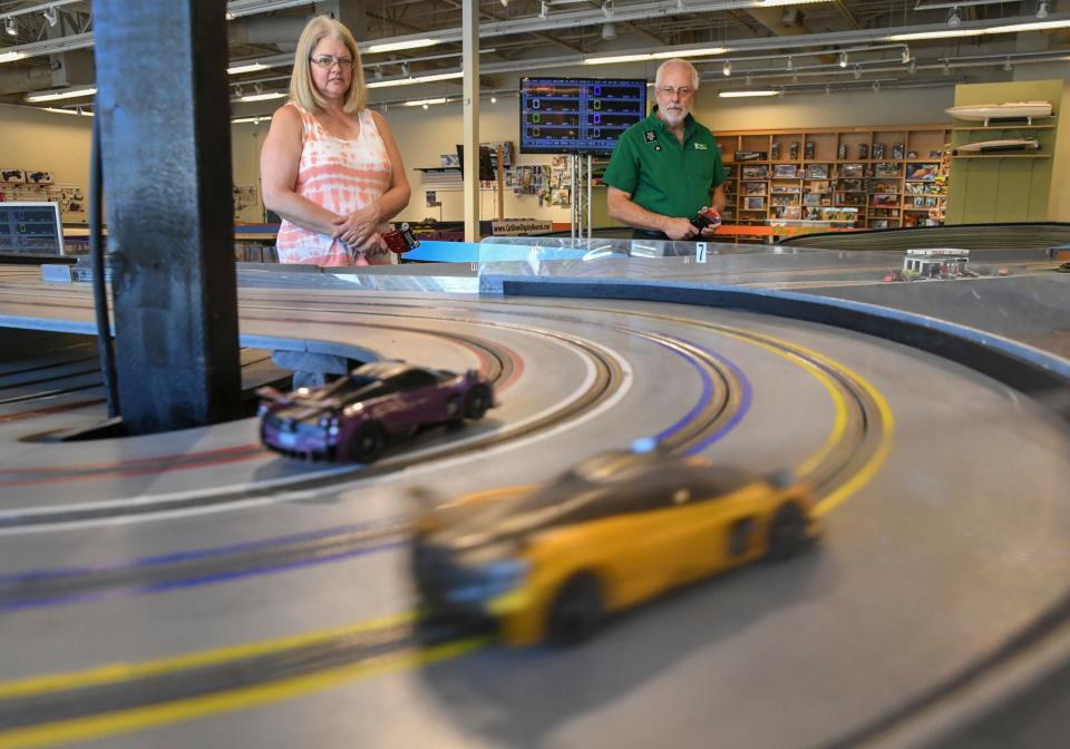 Sherry Striffler (left), of Fort Pierce, races alongside her husband,  Terry at the Slot Car Raceway and Hobby Shop on Sunday, June 11, 2023, in Vero Beach. The couple are among regulars at the raceway. "I like fast cars," she said.