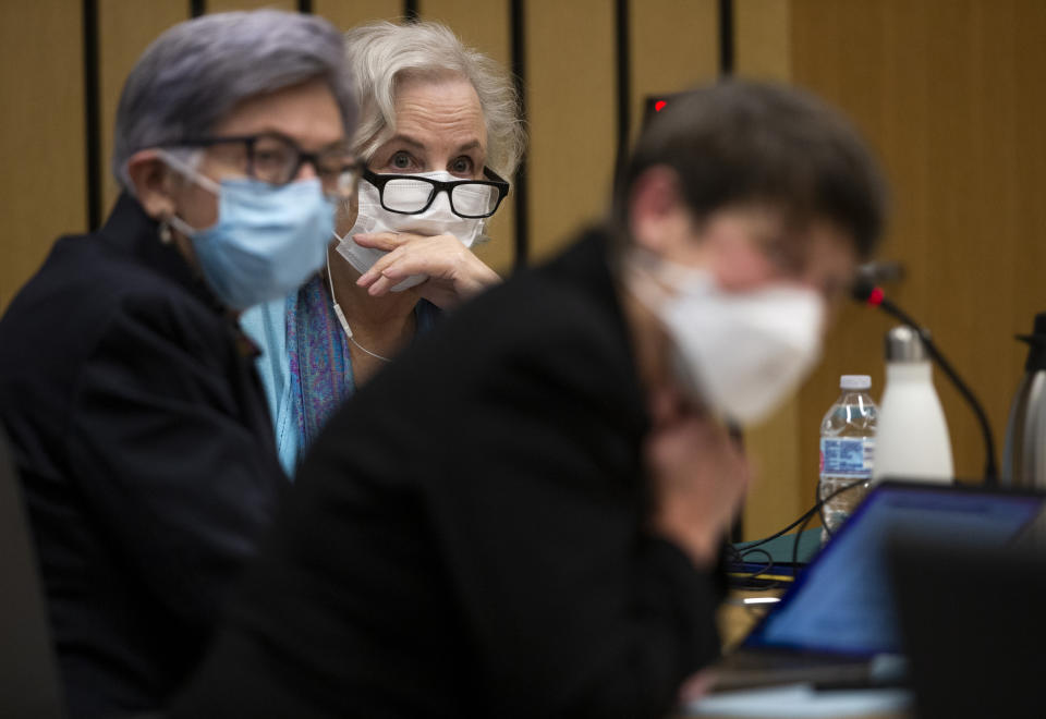 FILE - Romance writer Nancy Crampton Brophy, background, accused of killing her husband, Dan Brophy, in June 2018, is surrounded by her defense attorneys in court in Portland, Ore., Monday, April 4, 2022. A jury in Portland, Oregon, has convicted the self-published romance novelist — who once wrote an essay titled "How to Kill Your Husband" — of fatally shooting her husband four years ago. (Dave Killen/The Oregonian via AP, Pool, File Photo)