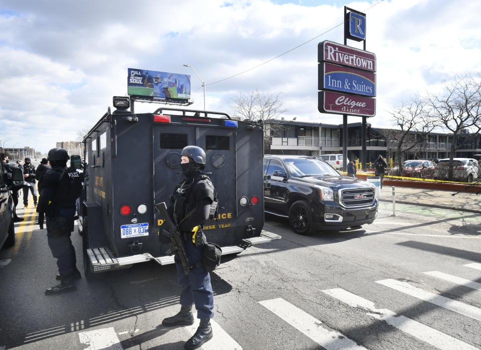 Detroit police monitor the scene of a shooting at the Rivertown Inn and Suites on East Jefferson Avenue in Detroit, Mich., on Monday, March 1, 2021. (Daniel Mears/Detroit News via AP)