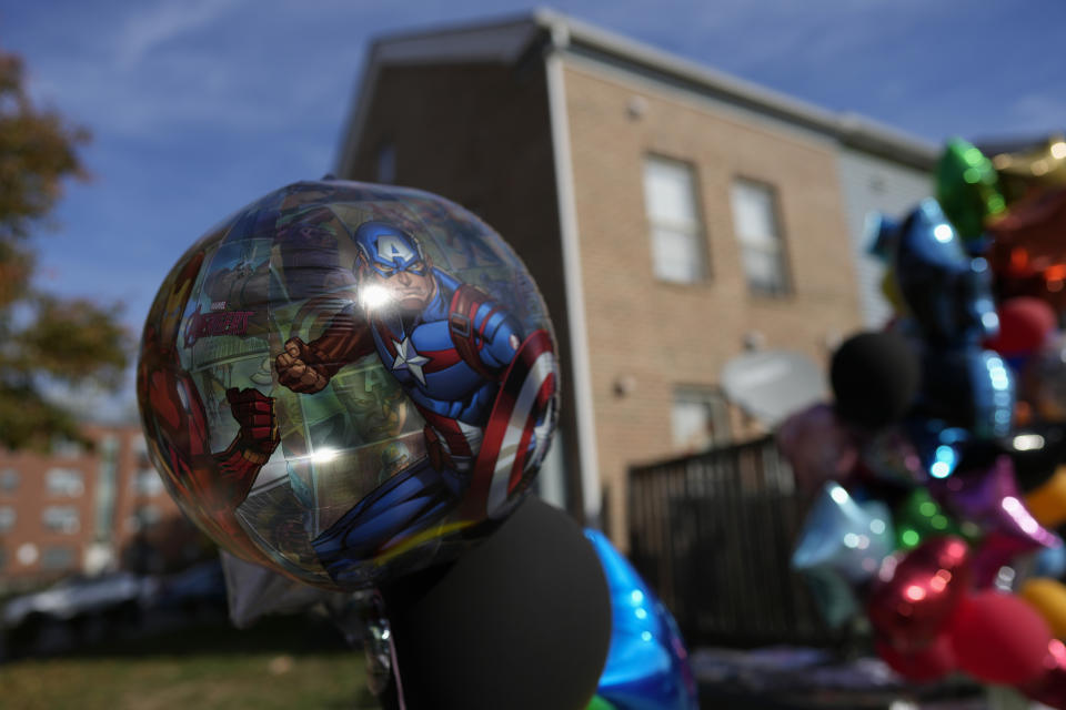 A superhero balloon with Captain America is part of a makeshift memorial for Dominic Davis, an 11-year-old boy, who was killed in a weekend shooting, Monday, Nov 6, 2023, in Cincinnati. Police Chief Terri Theetge told reporters Sunday that a shooter in a sedan fired 22 rounds "in quick succession" into a crowd of children just before 9:30 p.m. Friday on the city's West End. (AP Photo/Carolyn Kaster)