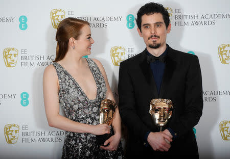 Emma Stone and Damien Chazelle hold their awards for 'La La Land' at the British Academy of Film and Television Awards (BAFTA) at the Royal Albert Hall in London, Britain, February 12, 2017. REUTERS/Toby Melville