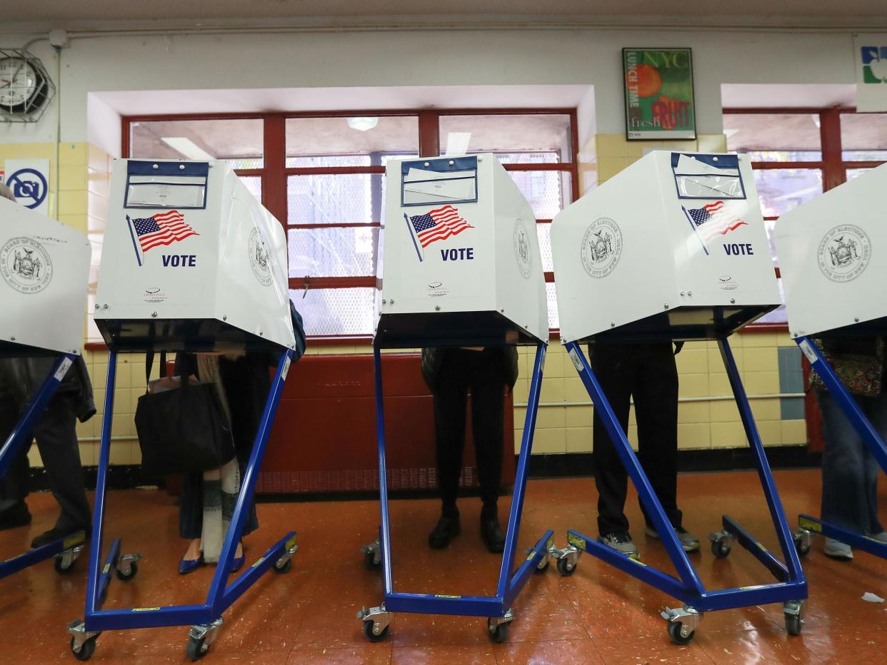 Voters casting their ballots in the US election last November. Despite winning the Electoral College vote, President Trump still alleges voter fraud took place: Michael Reaves/Getty Images