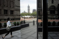 A passer-by wears a mask out of concern for the coronavirus while walking along a nearly empty street, Tuesday, July 7, 2020, in Boston. The U.S. stock market has been churning over the last month, with big daily moves up and down keeping it roughly in place. (AP Photo/Steven Senne)