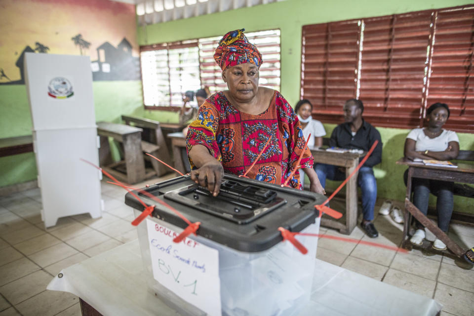 A woman votes at the Boulbinet Deaf School in Conakry, Guinea, Sunday Oct. 18, 2020. Guinean President Alpha Conde is seeking to extend his decade in power, facing off against his longtime rival Cellou Dalein Diallo for the third time at the polls. (AP Photo/Sadak Souici)