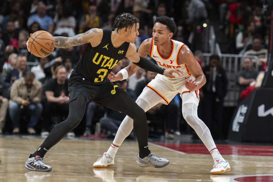 Utah Jazz guard Keyonte George (3) looks to pass against Atlanta Hawks guard Kobe Bufkin (4) during the second half of an NBA basketball game Tuesday, Feb. 27, 2024, in Atlanta. (AP Photo/Hakim Wright Sr.)