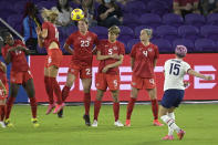 Canada forward Janine Beckie (16) deflects a penalty kick by United States forward Megan Rapinoe (15) during the first half of a SheBelieves Cup women's soccer match, Thursday, Feb. 18, 2021, in Orlando, Fla. (AP Photo/Phelan M. Ebenhack)