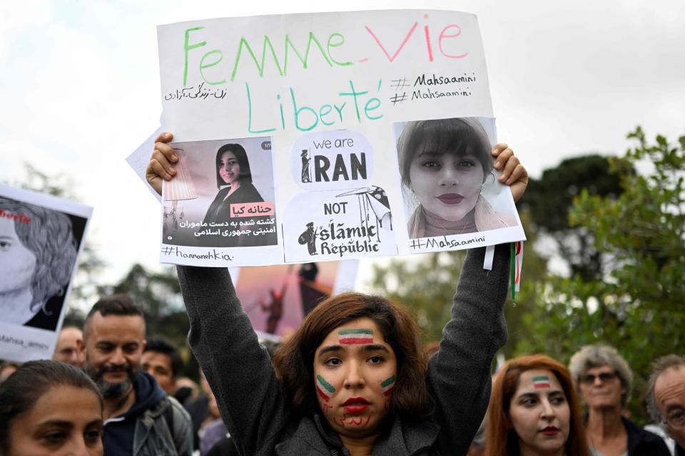 A protester holds a placard during a demonstration in support of Kurdish Iranian woman Mahsa Amini during a protest on Oct. 3, 2022, in Nantes, western France, following her death in Iran. - Amini, 22, died in custody on Sept. 16, 2022, three days after her arrest by the notorious morality police in Tehran for allegedly breaching the Islamic republic's strict dress code for women. in Nantes, western France on Sept. 29, 2022.