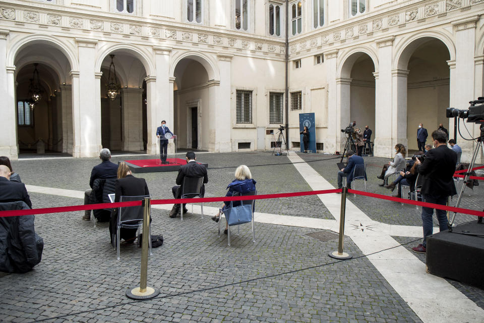 Italian Premier Giuseppe Conte announces new rules to curb the spread of COVID-19, in Rome, Sunday, Oct. 25, 2020. For at least the next month, people outdoors except for small children must now wear masks in all of Italy, gyms, cinemas and movie theaters will be closed, ski slopes are off-limits to all but competitive skiers and cafes and restaurants must shut down in early evenings, under a decree signed on Sunday by Italian Premier Giuseppe Conte, who ruled against another severe lockdown despite a current surge in COVID-19 infections. (Roberto Monaldo/LaPresse via AP)