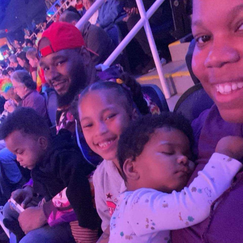 Elliott McNeil holding his son Zion, 6-year-old Karlie and Angelia Tutt holding their son, also named Elliott.