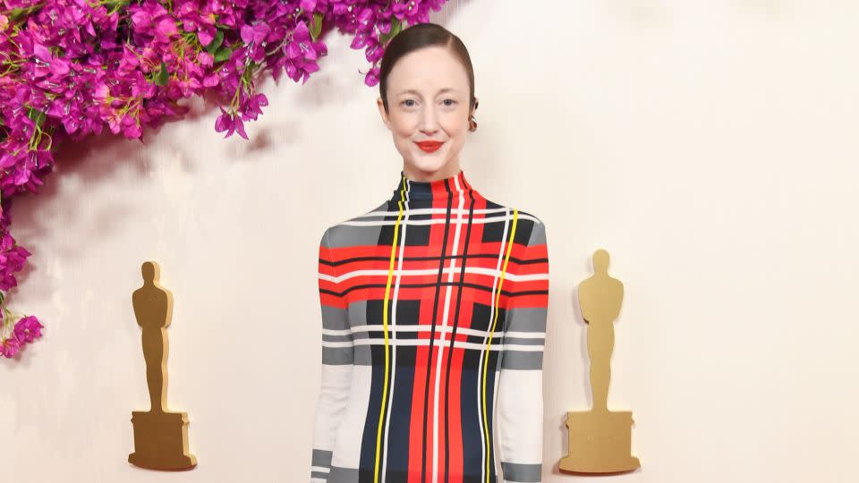 Andrea Riseborough wore an eye-catching long-sleeved Loewe dress with a tartan print. - Alberto Rodriguez/Variety/Getty Images