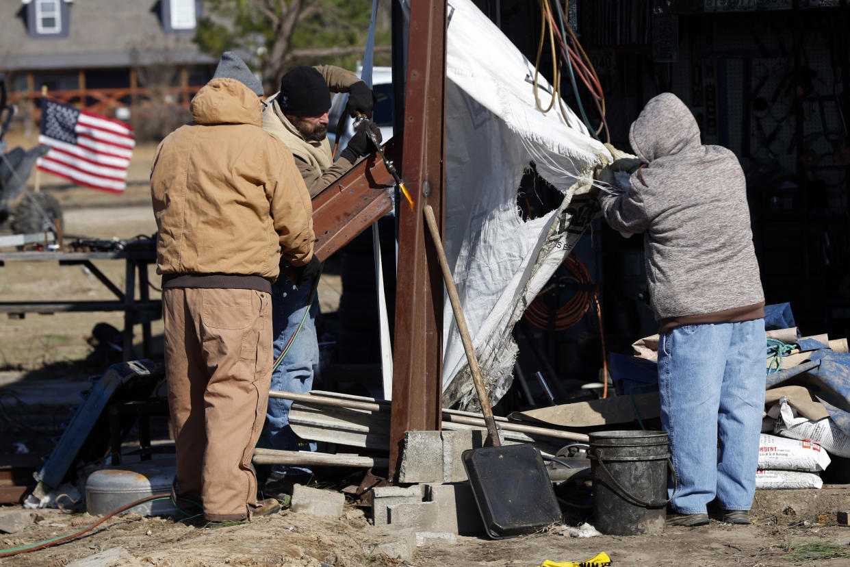 Friends and family help as they recover from a tornado that ripped through Central Alabama earlier this week along County Road 140 where loss of life occurred Saturday, Jan. 14, 2023, in White City, Autauga County, Ala. (AP Photo/Butch Dill)