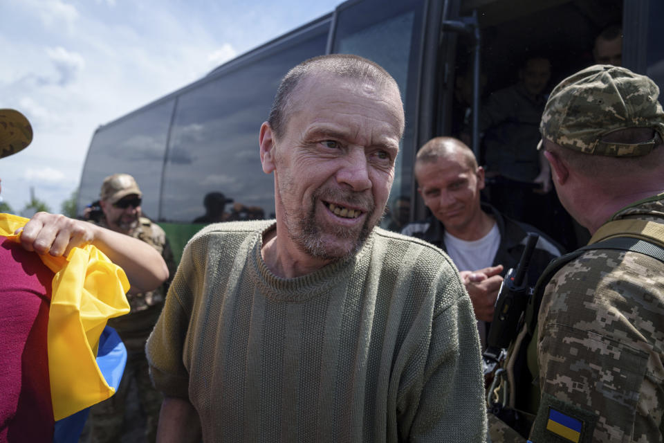 Ukrainian servicemen walk out from a bus after returning from captivity during POWs exchange in Sumy region, Ukraine, Friday, May 31, 2024. Ukraine returned 75 prisoners, including four civilians, in the latest exchange of POWs with Russia. It's the fourth prisoner swap this year, and 52nd since Russia invaded Ukraine. In all, 3 210 Ukrainian servicemen and civilians were returned since the outbreak of the war. (AP Photo/Evgeniy Maloletka)