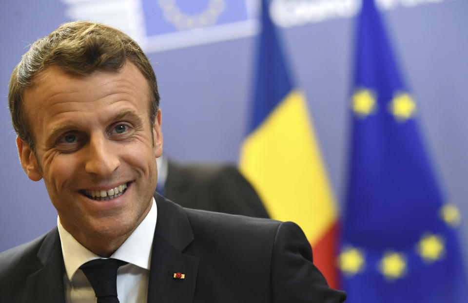 French President Emmanuel Macron speaks with the media during an EU summit at the Europa building in Brussels, Friday, June 21, 2019. European Union leaders have failed to back a plan to make the bloc's economy carbon neutral by 2050 in spite of promises to fight harder against climate change. (AP Photo/Riccardo Pareggiani)