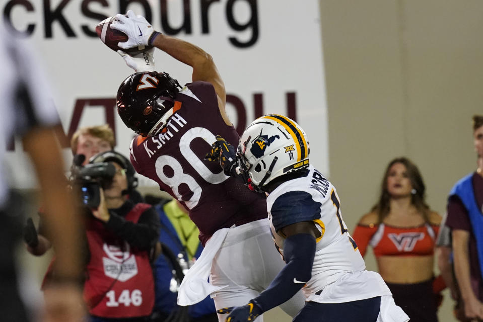 Virginia Tech wide receiver Kaleb Smith (80) hauls in a touchdown pass in front of West Virginia cornerback Wesley McCormick (11) during the first half of an NCAA college football game Thursday, Sept. 22, 2022, in Blacksburg, Va. (AP Photo/Steve Helber)