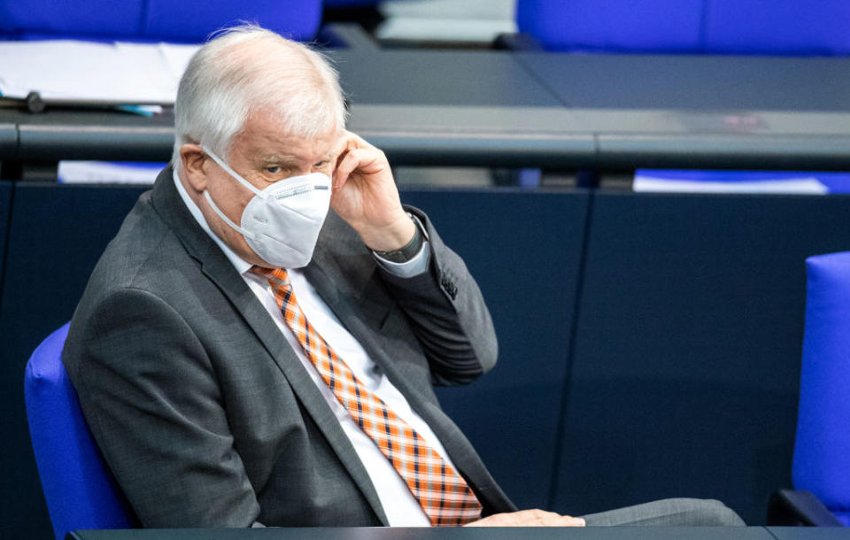 28 January 2021, Berlin: Horst Seehofer (CSU), Federal Minister of the Interior, for Construction and Home Affairs, directs his mouth-nose-covering during the plenary session in the German Bundestag. The main topics of the 206th session of the 19th legislative period are the annual economic report, a bill to increase IT security for critical infrastructure, the ordinance on the listing of election candidates under Corona conditions and the draft law on the mobilization of building land. Photo: DorothÃ©e Barth/dpa (Photo by DorothÃ©e Barth/picture alliance via Getty Images)