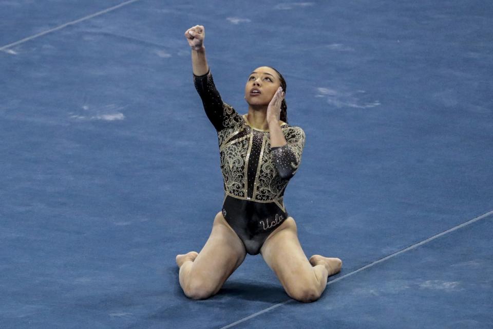 UCLA gymnast Margzetta Frazier flashes the "Black power" sign.