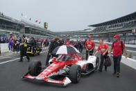 The crew for Marcus Ericsson, of Sweden, push his car back to Gasoline Alley during a weather delay during qualifications for the Indianapolis 500 auto race at Indianapolis Motor Speedway, Saturday, May 21, 2022, in Indianapolis. (AP Photo/Darron Cummings)