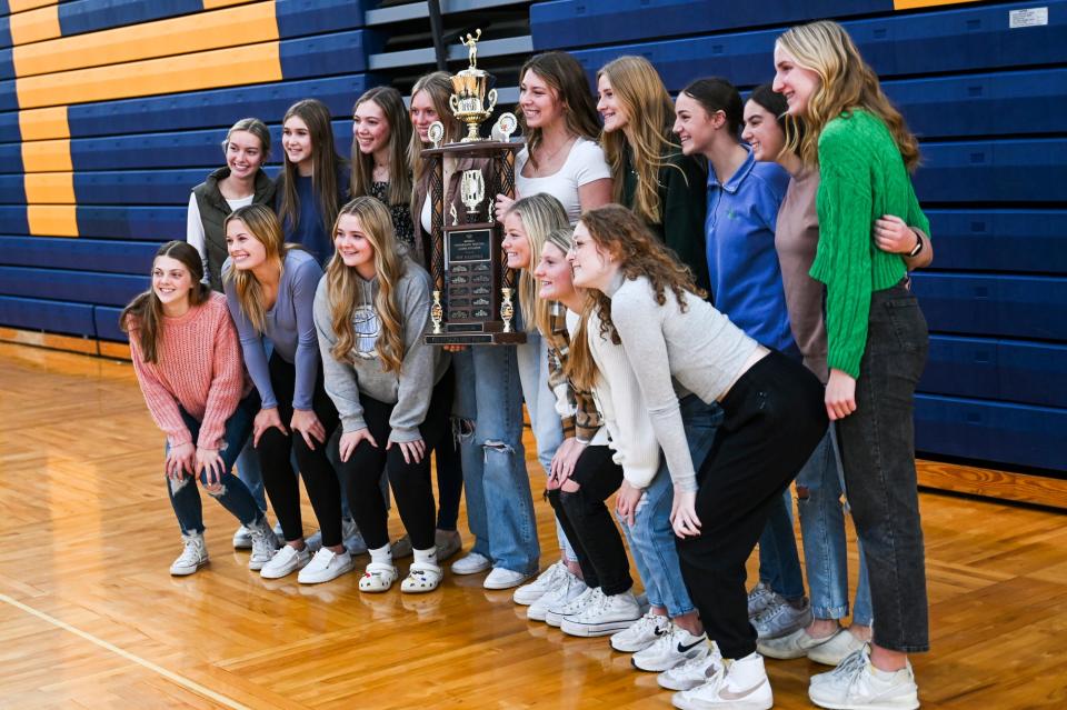 Miss Volleyball Taylor Smith, center, poses with the rest of the Pewamo-Westphalia volleyball team after Smith was named Miss Volleyball during a surprise ceremony on Monday, Nov. 13, 2023, at Pewamo-Westphalia High School. The award is presented by the Detroit Free Press and the Michigan Interscholastic Volleyball Coaches Association.