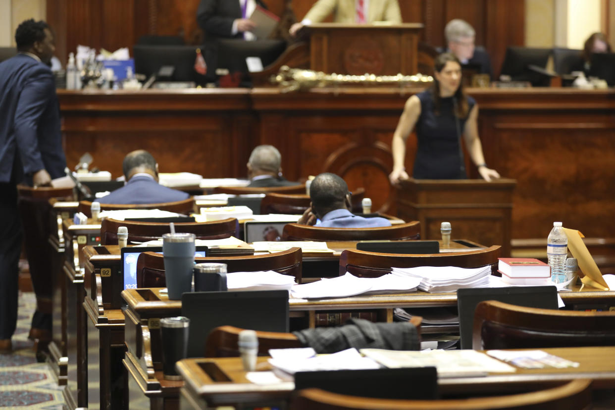 Papers sit on empty desks in the South Carolina House as representatives discuss an abortion bill, Wednesday, May 17, 2023, in Columbia, S.C. (AP Photo/Jeffrey Collins)