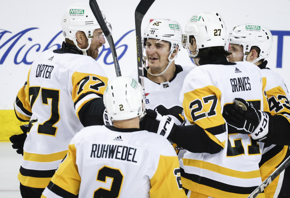 Pittsburgh Penguins forward Jeff Carter (77) and teammates celebrate his goal against the Calgary Flames during the third period of an NHL hockey game Saturday, March 2, 2024, in Calgary, Alberta. (Jeff McIntosh/The Canadian Press via AP)