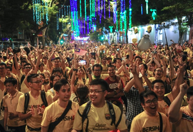 Protesters cheer at the end of their 34-hour anti-government rally in Kuala Lumpur, early on August 31, 2015