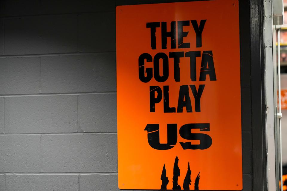 A mounted sign reads, “They Gotta Play Us” next to the locker room door headed to the field at Paycor Stadium in downtown Cincinnati on Wednesday, Jan. 25, 2023.