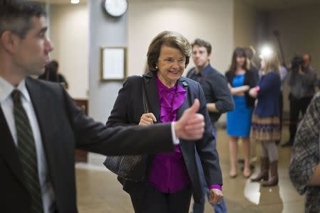 U.S. Senator Dianne Feinstein (D-CA) (C) smiles as she arrives for votes on the Senate floor at the U.S. Capitol in Washington December 12, 2014. REUTERS/Jonathan Ernst