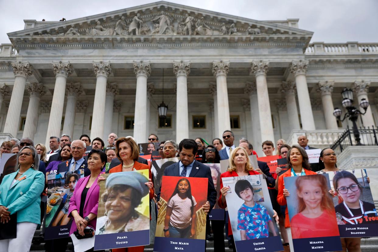 Speaker of the House Nancy Pelosi (D-CA) stands with fellow Democrats holding photographs of the victims of the mass shootings in Buffalo, New York and Uvalde, Texas, before passing the Bipartisan Safer Communities Act in front of the House of Representatives on June 24, 2022 in Washington, DC. 