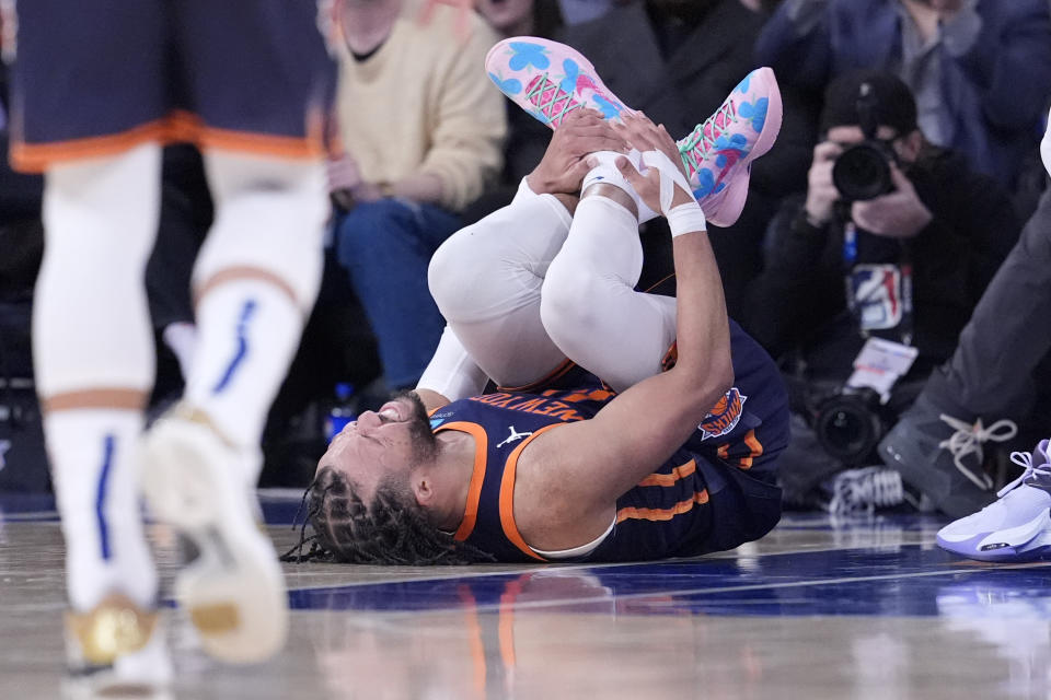 New York Knicks guard Jalen Brunson grimaces as he holds on to his ankle during the second half of an NBA basketball game against the Memphis Grizzlies, Tuesday, Feb. 6, 2024, at Madison Square Garden in New York. The Knicks won 123-113. (AP Photo/Mary Altaffer)