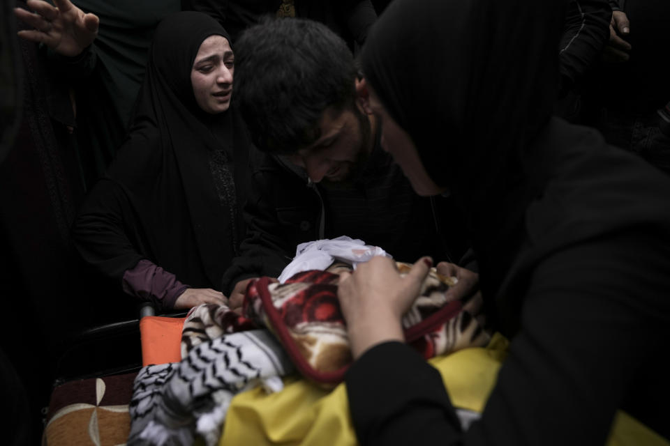 Mourners take a last look at the body of Palestinian Fulla al-Masalmeh,15, during her funeral in the West Bank village of Beit Awwa, Tuesday, Nov. 15, 2022. The Palestinian Health Ministry says Israeli forces shot and killed a 15-year-old Palestinian girl during a pre-dawn raid in the occupied West Bank. The circumstances surrounding the death of the teenage girl in the city of Beitunia in the central West Bank, identified by Palestinian health officials as Fulla al-Masalmeh, were not fully clear. The Israeli military said soldiers opened fire on a vehicle that was accelerating toward them after they signaled for it to stop. The military said it was investigating, and declined to comment further. (AP Photo/Mahmoud Illean)