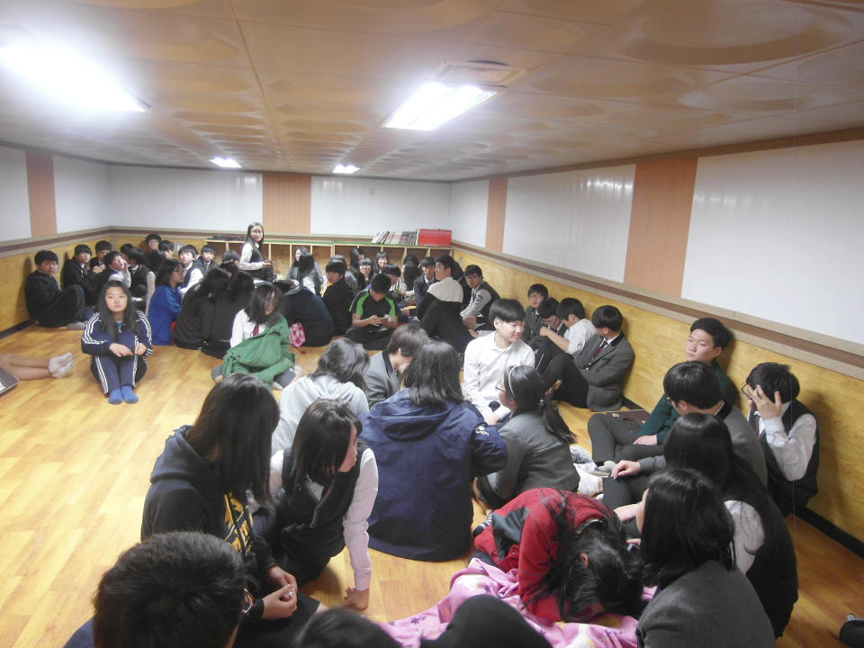 Residents and students of Yeonpyeong Island evacuate to a shelter on the island, South Korea, near the West Sea border with North Korea, Monday, March 31, 2014. North and South Korea fired artillery shells into each other's waters Monday, a flare-up of animosity between the rivals that forced residents of five front-line South Korean islands to evacuate to shelters, South Korean officials said. (AP Photo) KOREA OUT