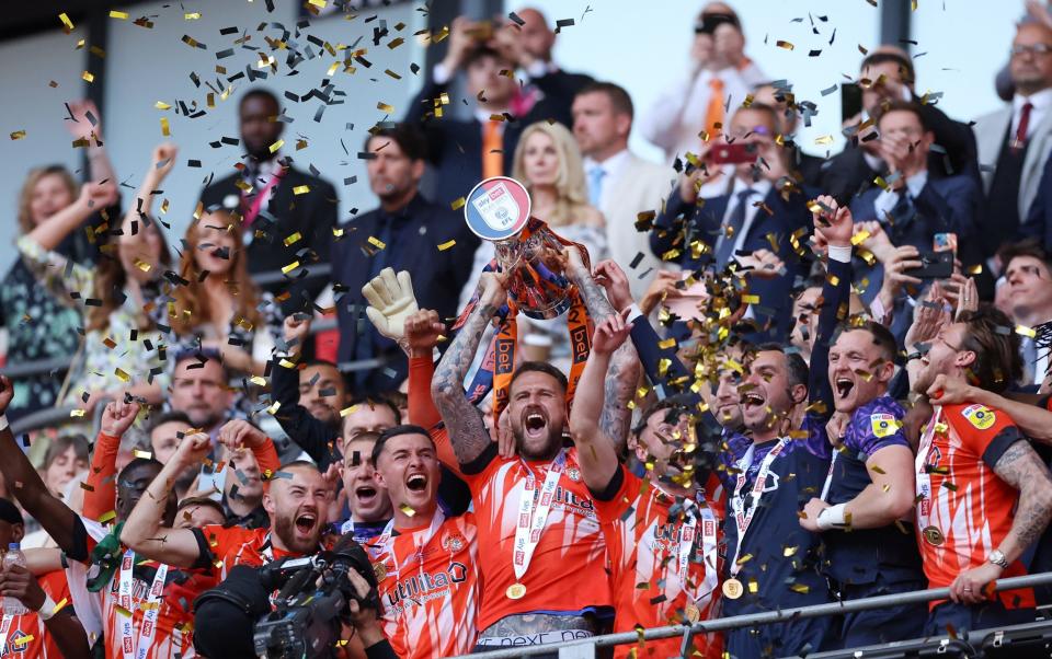 Sonny Bradley of Luton Town lifts the Sky Bet Championship Play Offs Final - Getty Images/Alex Pantling