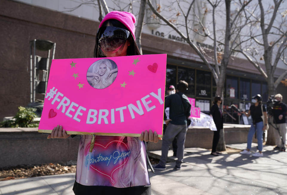 A Britney Spears supporter who gave her name as A.J. stands outside a court hearing concerning the pop singer's conservatorship at the Stanley Mosk Courthouse, Thursday, Feb. 11, 2021, in Los Angeles. (AP Photo/Chris Pizzello)