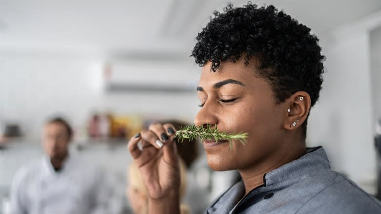 Woman smelling rosemary