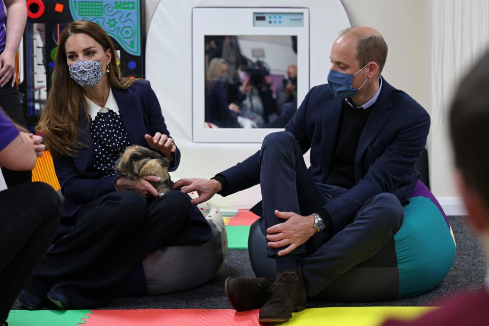 Prince William and Duchess Kate of Cambridge handle Milly the rabbit as they join a group of local school children during a visit to HugglePets in the Community to mark Mental Health Awareness Week on May 13, 2021 in Wolverhampton, England.