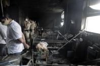 People inspect an ICU ward after a fire broke out in Vijay Vallabh COVID-19 hospital at Virar, near Mumbai, India, Friday, April 23, 2021. A fire killed 13 COVID-19 patients in a hospital in western India early Friday as an extreme surge in coronavirus infections leaves the nation short of medical care and oxygen. (AP Photo)