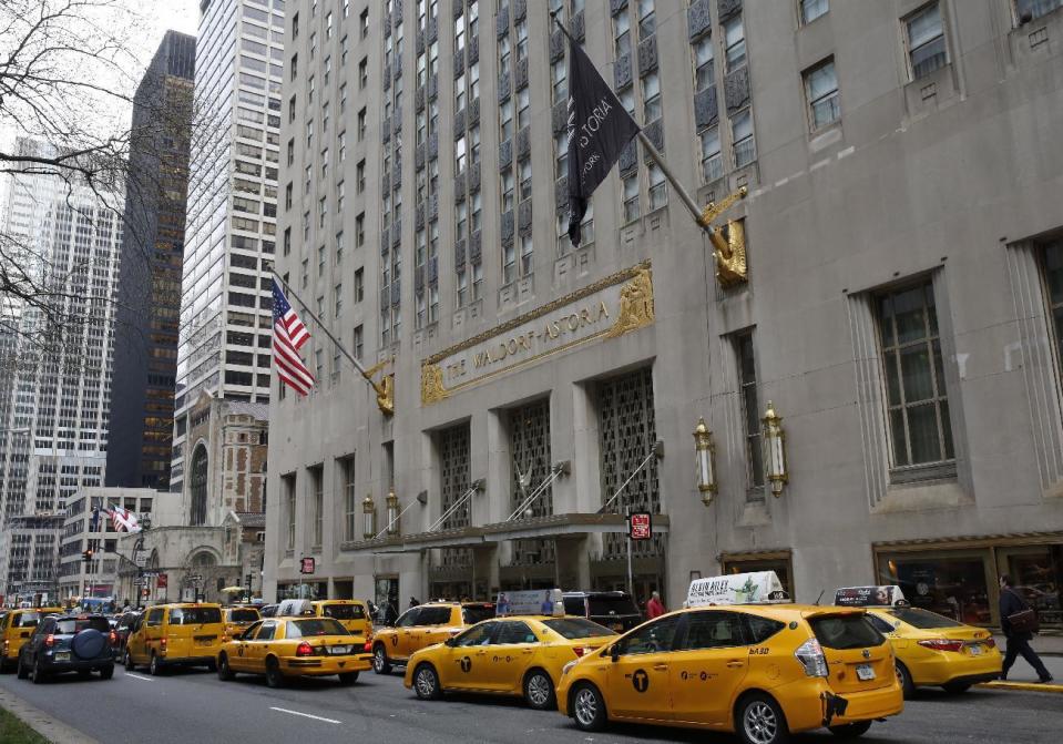 Taxis line up in front of the renowned Waldorf Astoria hotel, Tuesday, Feb. 28, 2017, in New York. The hotel, purchased by the Anbang Insurance Group, a Chinese company, is closing Wednesday for two to three years for renovation. Exact details of the renovation haven't been released, but its conversion into a hybrid of private residences and a smaller hotel follows a model set by another landmark New York City hotel, The Plaza. The exterior is protected by law as a New York City landmark, but some fans are still nervous about the future. (AP Photo/Kathy Willens)