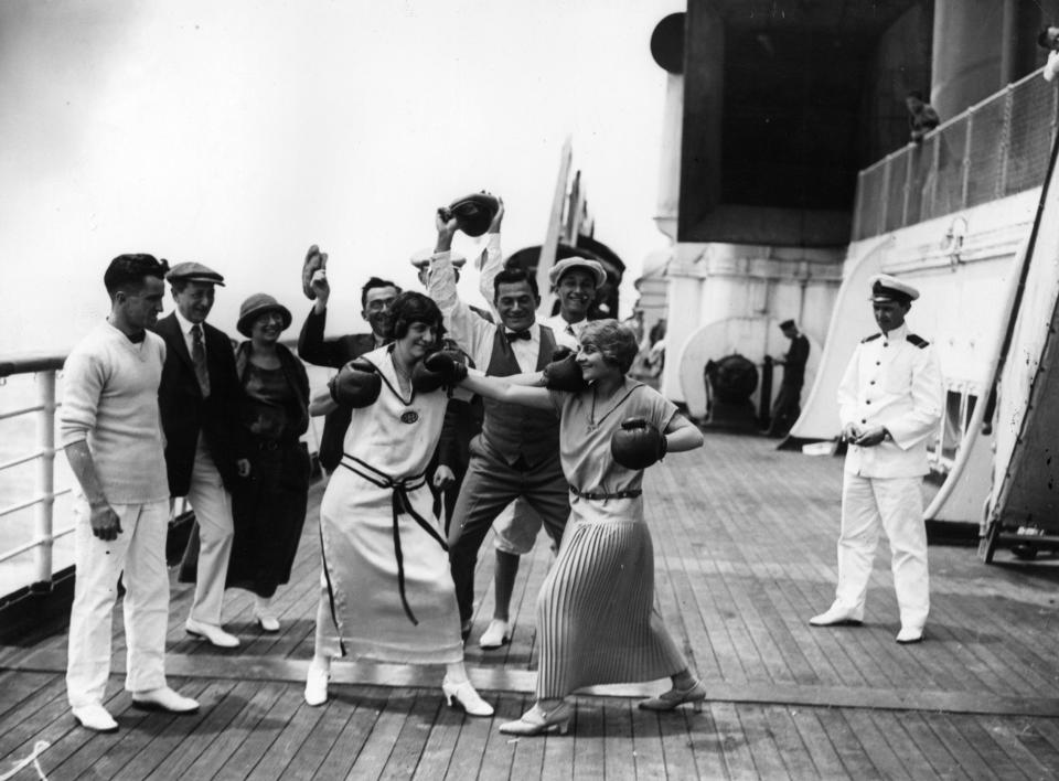 uly 1923: Two women passengers boxing aboard Cunard liner 'Berengaria' watched by fellow passengers and an officer.